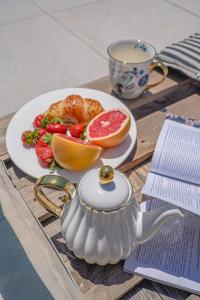 a table with a plate of fruit and a cup of coffee at Casa Frutta in Petrich