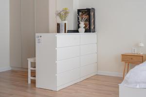 a white chest of drawers in a bedroom at Casa Frutta in Petrich