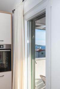 a sliding glass door with a view of a balcony at Adria in Vodice +10 photos