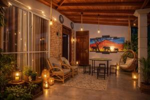 a living room with a table and chairs and lights at Ocean Green Villa in Matara