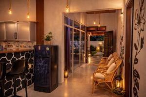 a kitchen with a group of chairs and a counter at Ocean Green Villa in Matara