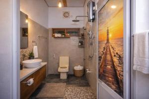 a bathroom with a toilet and a view of a beach at Ocean Green Villa in Matara