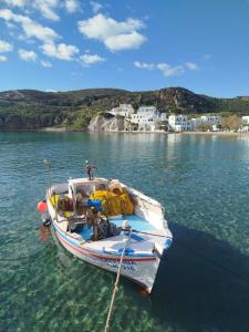 a boat is docked in the water on a lake at Ventalia in Kimolos +16 photos