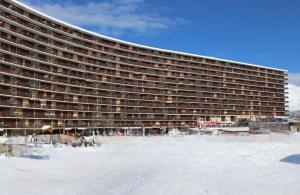 a large building with snow in front of it at Appartement T1 Superdévoluy 6 personnes in Le Dévoluy