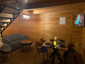 a living room with a table and a couch at Brvnara Zoja - Zlatar in Prorečane