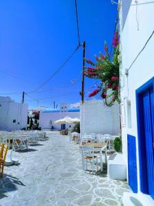 a group of chairs and tables on a street at Ventalia in Kimolos