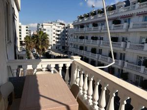 a balcony with a bench and a building at Sunny And Waves Apartment in Golem