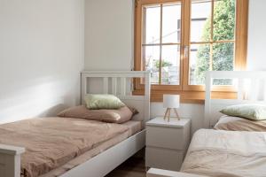 a bedroom with two bunk beds and a window at Alpenblick in Beatenberg