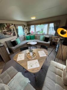 a living room with a table and a couch at Seaton Sands 71 Aberlady in Port Seton