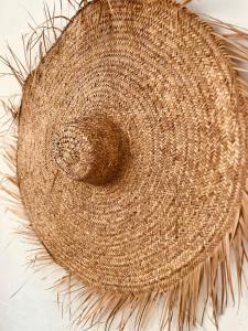 a straw hat sitting on top of a table at Finca W - Coín - Málaga - Andalucía in Coín