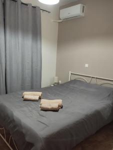 two towels sitting on a bed in a room at Gianis Homme in Alexandroupoli