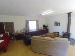 a living room with a couch and a fireplace at The Cosy Cottage in Port Sorell