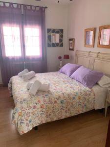 a bedroom with a bed with two towels on it at El balcón de Araceli in Cercedilla