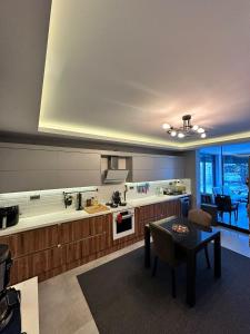 a large kitchen with a table in a room at Villa Dream in Kuşadası
