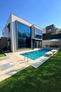 a swimming pool in front of a house at Villa Dream in Kuşadası