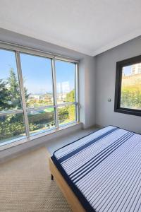 a bedroom with a bed and two windows at Villa Dream in Kuşadası +25 photos