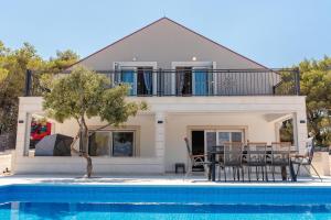 a villa with a swimming pool and a house at Villa Maris in Povlja