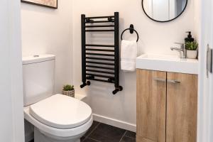 a bathroom with a white toilet and a sink at That's Amore House 3 bedroom house with parking walking distance to Sandbach town in Sandbach +16 photos