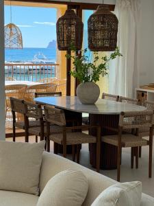 a dining room with a table and chairs with a view of the ocean at ALTEA LUXURY - Blue Pearl in Altea la Vieja