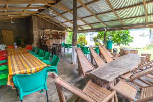 a group of chairs and a table in a restaurant at Wli Waterfalls Inn,My Home Your Home in Wli Afegame