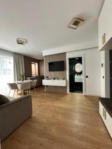 a living room with a couch and a table at Sara Home in Baia Mare