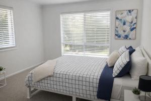 a bedroom with a bed with pillows and a window at Pandora Place in Lightning Ridge