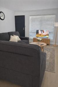 a living room with a couch and a table at Pandora Place in Lightning Ridge