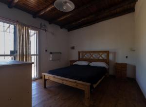 a bedroom with a bed and a large window at CABAÑAS EL CERRO in Ciudad Lujan de Cuyo +37 photos