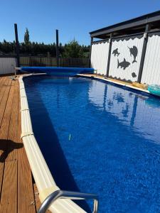 a large swimming pool on a wooden deck at Rakanui Hidden Retreat in Hilderthorpe