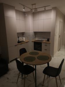 a kitchen with a table and chairs in a room at Nocleg Zagnańska in Kielce