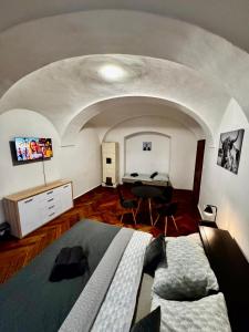 a bedroom with a bed and a desk in a room at Lacná izba v centre in Banská Bystrica