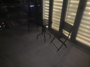 a table and two chairs in a room with windows at Nocleg Zagnańska in Kielce +6 photos