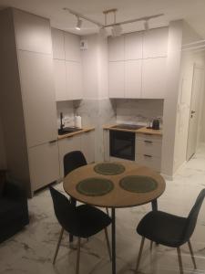 a kitchen with a table and chairs in a room at Nocleg Zagnańska in Kielce