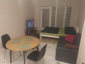 a living room with a bed and a table and chairs at Nocleg Zagnańska in Kielce