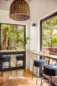a room with a bar with stools and a window at Villa Sea Breeze in West End