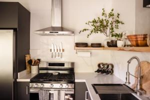 a kitchen with a stove and a sink at Villa Sea Breeze in West End