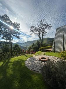 a garden with a stone circle in the grass at Cabana Branca luxo in Teresópolis