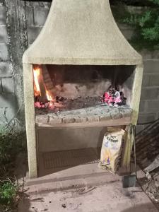 a stone oven with a fire inside of it at Los eucaliptos in Andino
