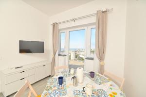 a dining room with a table and a view of the ocean at La Perla Sul Mare in Forio d'Ischia