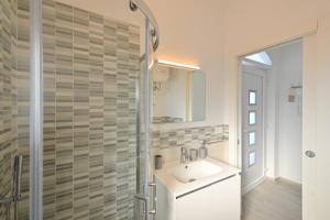 a bathroom with a sink and a shower at La Perla Sul Mare in Forio d'Ischia +48 photos