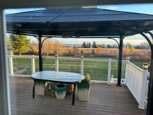 a patio with a blue table on a deck at Lakeview in Colborne
