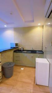 a kitchen with a sink and a refrigerator at شاليهات واحة لافندر in Taif