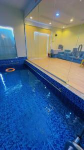 a swimming pool with a mirror and a tennis court at شاليهات واحة لافندر in Taif