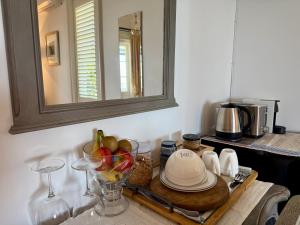a table with a bowl of fruit and a mirror at Villa Victoria - Nelson in Nelson