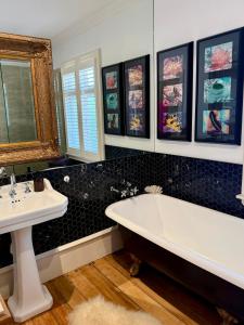 a bathroom with a white tub and a sink at Villa Victoria - Nelson in Nelson +20 photos