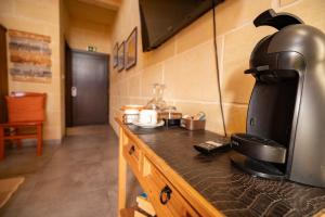 a coffee maker on a counter in a kitchen at Ajuga Luxury Boutique B&B in Qala