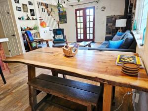 a living room with a wooden table and a couch at Sky Cabin in Aptos +26 photos