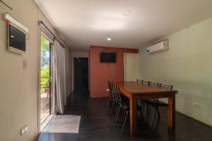 a dining room with a wooden table and chairs at CABAÑAS EL CERRO in Ciudad Lujan de Cuyo