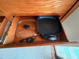 a box with a tv in a wooden drawer at Surfers Dream Studio in Waianae