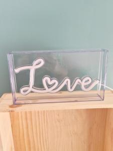 a clear glass box with a sign that says love at Studio cosy in Burlats